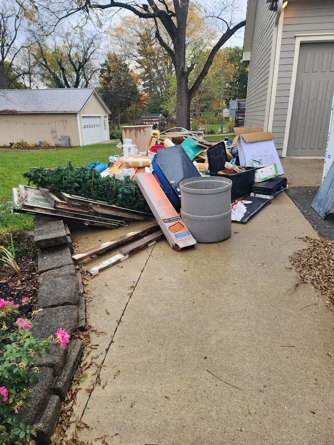 Dumpster being loaded with debris for Estate Cleanout Dumpster Rental in Crowley